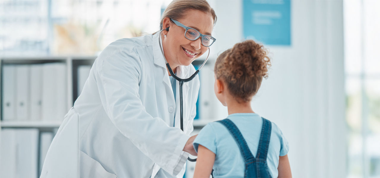 female pediatric providing care to young girl